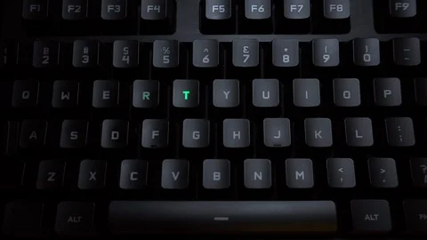 The word training is typed on a luminous computer keyboard. Black backlit Stock Footage 118277205
