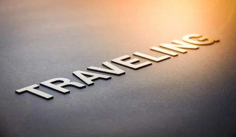  Word traveling written with white solid letters Word traveling written wi... Foto stock