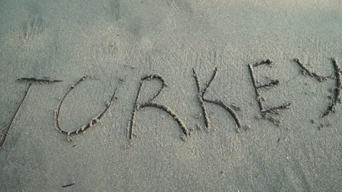 Word Turkey on sandy beach Stock Footage 93112584
