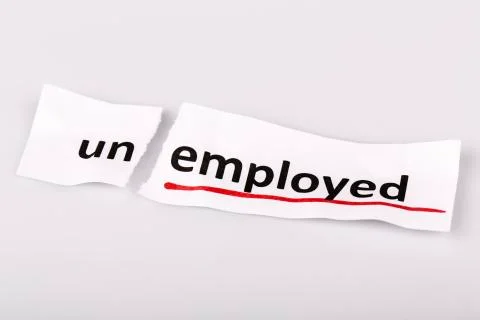 The word unemployed changed to employed on torn paper and white background Stock Photos