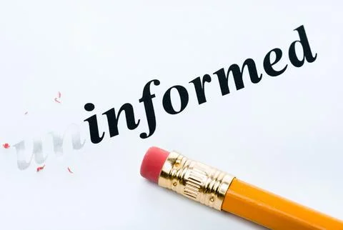 Word uninformed informed with eraser close-up Stock Photos