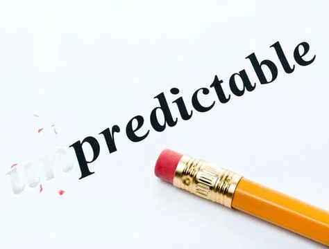 Word unpredictable and predictable with eraser close-up Stock Photos