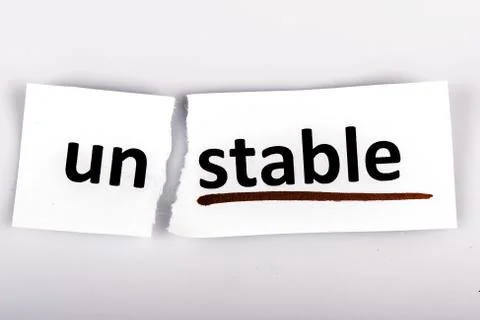 The word unstable changed to stable on torn paper Stock Photos