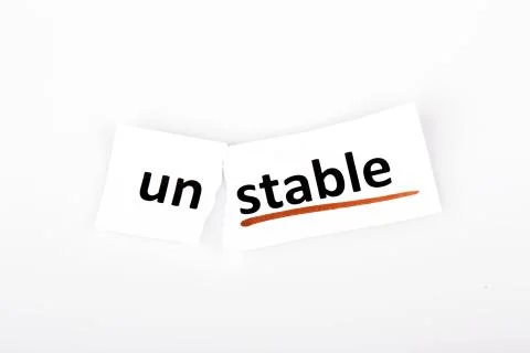 The word unstable changed to stable on torn paper Stock Photos