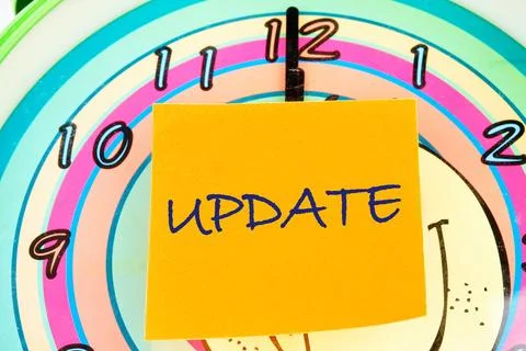 The word UPDATE on the sticker on the background of the watch face Stock Photos
