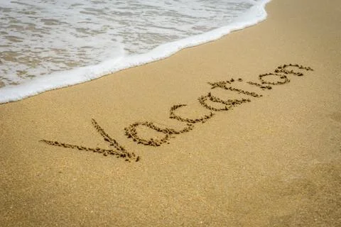 Word vacation on the beach sand - vacation and travel concept Stockfoto's