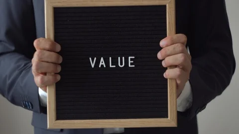 Word Value from Letters on Text Board in Anonymous Businessman Hands Stock Footage 91399059