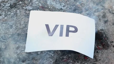 Word Vip on a white sheet of paper burns into a fire against. Slow motion Vídeo Stock 140116111