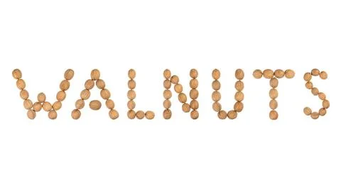 Word walnuts lined with walnuts isolated on white Stock Photos