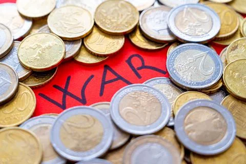 Word "war" on a red background and coins beside it. Trade wars and economic sanc Stock Photos