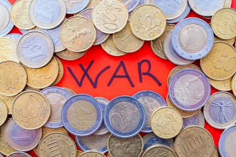 Word "war" on a red background and coins beside it. Trade wars and economic sanc Stock Photos