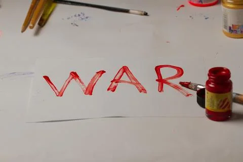 The word war is written in red in a creative setting. Stock Photos