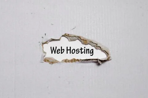 The word web hosting appearing behind torn paper Stock Photos