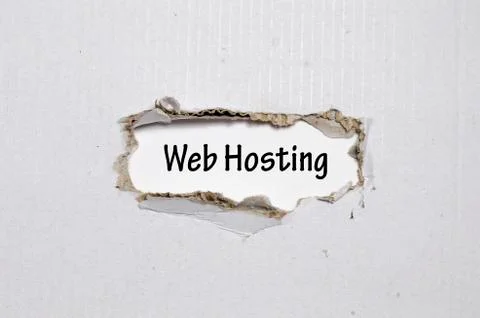 The word web hosting appearing behind torn paper Stock Photos