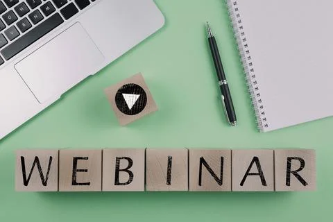 Word WEBINAR and play button symbol on wood cubes against green background with Stock Photos