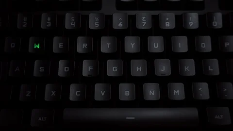 The word weed is typed on a luminous computer keyboard. Black backlit keyboard Stock Footage 118277244
