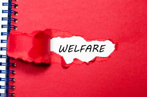 The word welfare appearing behind torn paper Stock Photos