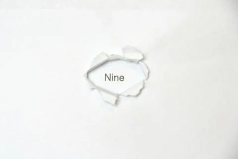 Word on white isolated background through the wound hole in the paper. Stock Photos