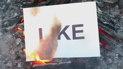 Word Like on a white sheet of paper burns into a fire against. Slow motion Vídeo Stock 138632004