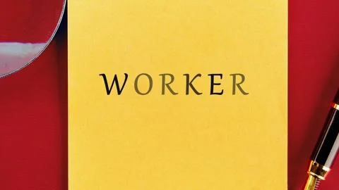 The word worker is printed on a yellow sticky note with a magnifying glass and Stock Footage 343639680