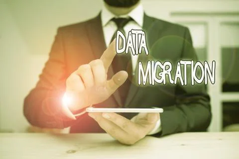 Word writing text Data Migration. Business concept for process of transferring Stock Photos