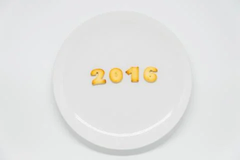 Word year 2016 cracker on dish with white background Foto stock