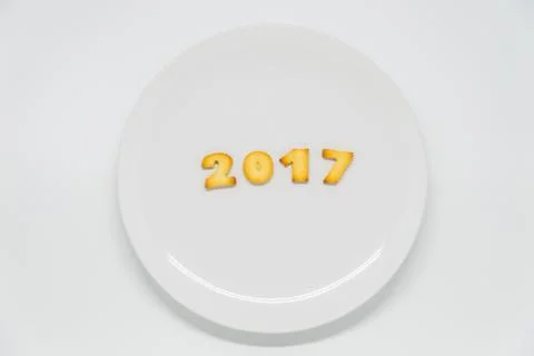 Word year 2017 cracker on dish with white background Stock Photos