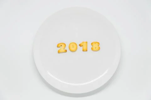 Word year 2018 cracker on dish with white background Stock Photos
