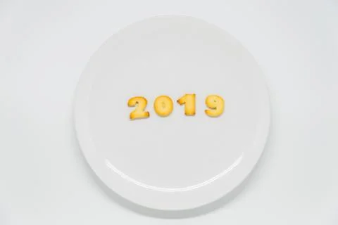 Word year 2019 cracker on dish with white background Stock Photos