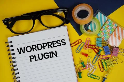 Wordpress Plugin text with eyeglasses and stationery on yellow background Stock Photos