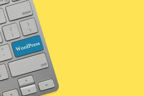 WORDPRESS text on keyboard over yellow background. Business and technology co Stock-Fotos