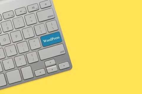 WORDPRESS text on keyboard over yellow background. Business and technology co Stock Photos