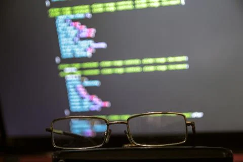 Wordpress theme code close up through sunglasses. Laptop screen with CSS code Stock Photos