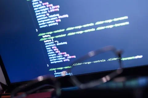 Wordpress theme code close up through sunglasses. Laptop screen with CSS code Stock Photos