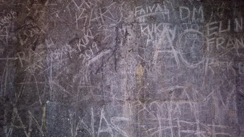 Words and marks etched into a stone wall Video stock 132149246