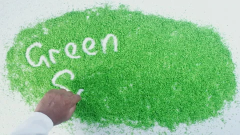 Words green solutions written in green sand Stock Footage 248632774