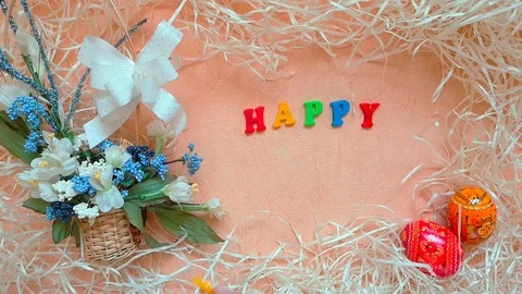 Words "Happy Easter", basket with flowers and Easter eggs Stock Footage 104084796