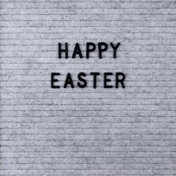 The words Happy Easter on grey felt letter board Stock Photos