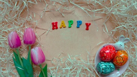 Words "Happy Easter", tulips, easter eggs on plate with bunny Stock Footage 104084791