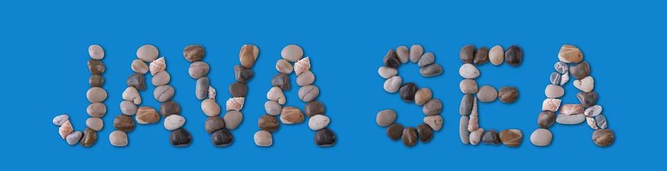 The words "JAVA SEA" are lined with seashells and stones of various shapes on Foto stock