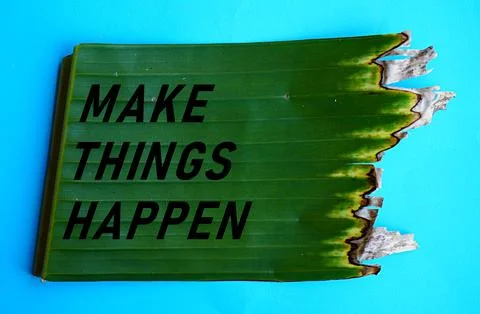 The words make things happen on torn green banana leaves, self-development Stock-Fotos
