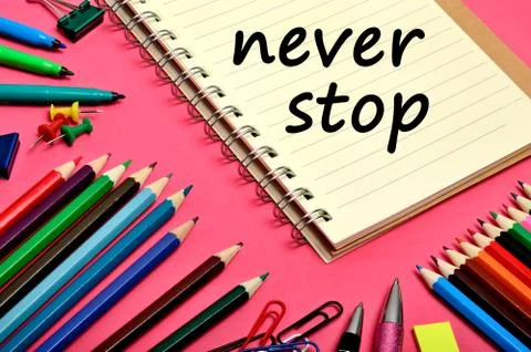 The words Never stop on notebook Stock Photos