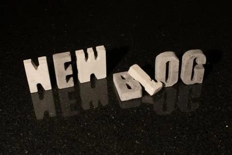 Words New Blog as grey concrete letters on black tile Stock Photos