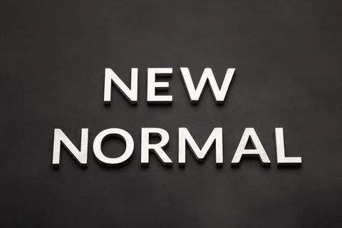 Words new normal on black surface in flat lay perspective Stockfoto's