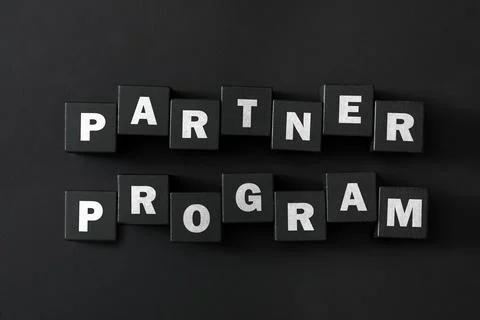 Words Partner Program made of cubes with letters on black background, top vie 스톡 사진