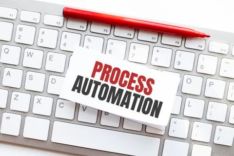 Words PROCESS AUTOMATION written on torn paper on a computer keyboard Stock Photos