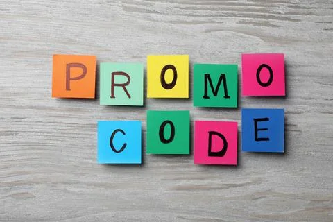 Words Promo Code made of colorful paper notes with letters on wooden table, f Stock Photos