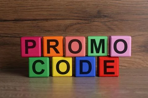 Words Promo Code made of colorful cubes with letters on wooden table Stock Photos