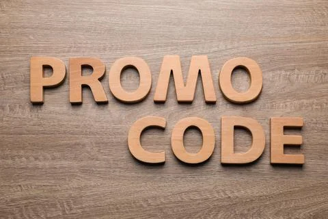 Words Promo Code made of letters on wooden table, flat lay Stock Photos