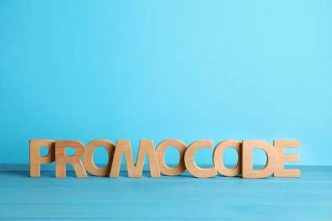 Words Promo Code made of wooden letters on turquoise table, space for text Stock-Fotos